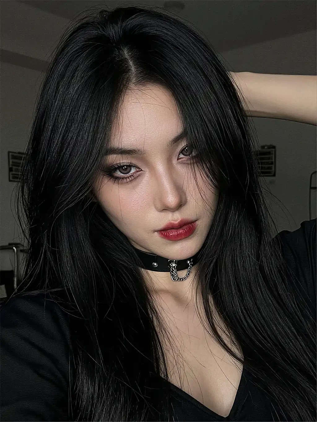 Fictional adult AI character on the NSFW chat page, in close-up with red lipstick and a studded choker
